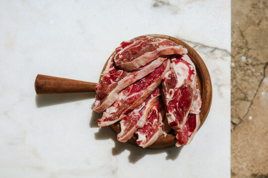 Fresh Cuts of Meat on a Wooden Board Ready for Cooking