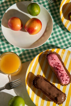 Sweet Treats and Fruits on a Table with Colorful Napkins