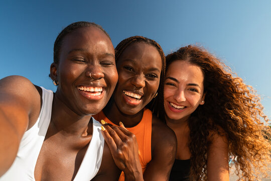 Friends Enjoy Time at the Street Taking a Selfie Under Clear Blue Sky