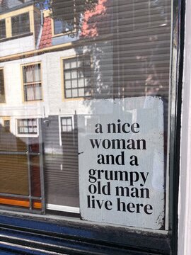 funny sign behind window