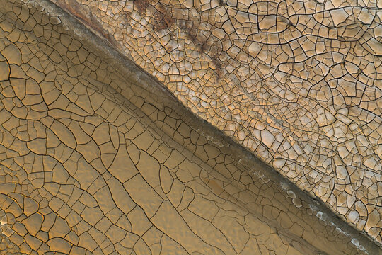 Aerial view of the cracked earth patterns and dry mud textures of Gora Bokty in Karakiya District, Mangystau Region, Kazakhstan.