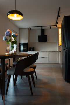 Contemporary Kitchen and Dining Area with Warm Lighting