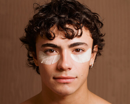Man With Under-Eye Patches in a Simple Room