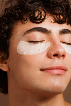Skin Care Treatment With Eye Patches on a Young Man in a Room