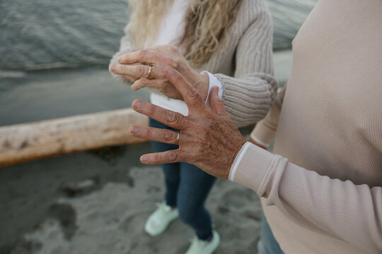 Couple holding hands on beach showing love and connection