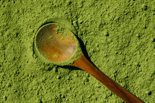 Matcha powder and wooden spoon