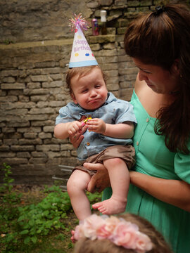 Baby boy looking very unsure on his birthday