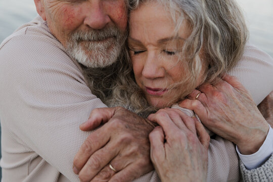 Candid portrait of an elderly couple sharing a tender hug