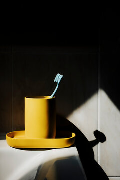Toothbrush and Holder on Sink in Bathroom