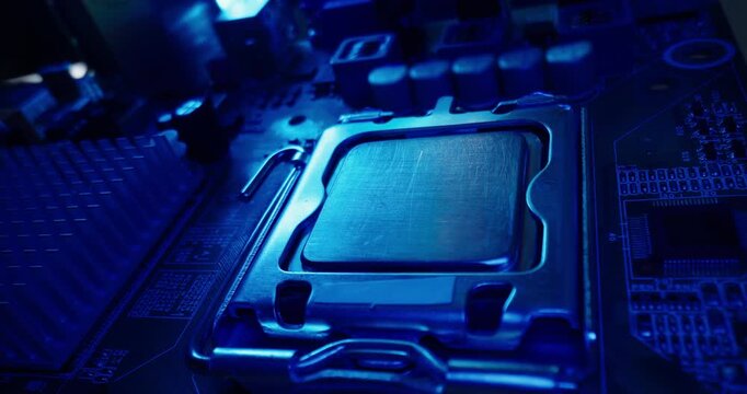 Tracking shot close up of cpu processor and socket on motherboard in electronics lab under blue metallic lighting, probe macro view.