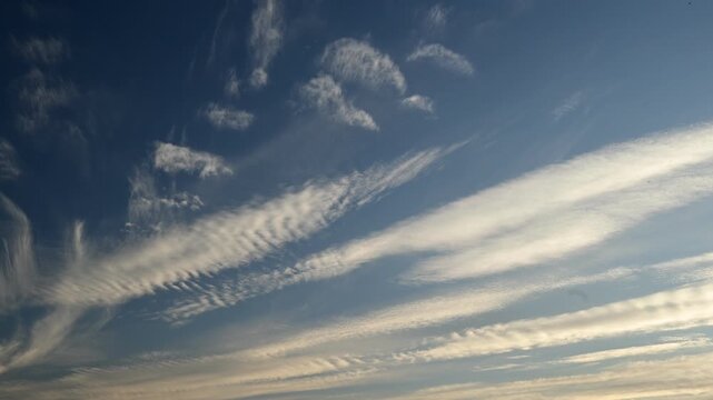 long parallel cloud streaks illuminated from below by warm sunlight