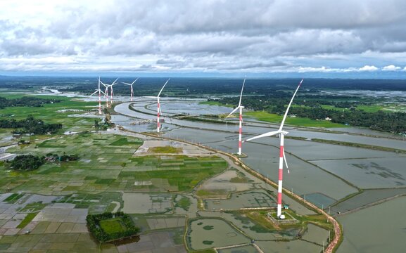 Aerial view of Cox's Bazar 60 MW Wind Power Plant with turbines in a landscape of flooded fields and green vegetation in Cox's Bazar, Chittagong Division, Bangladesh.