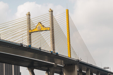 Naklejka premium Yellow Cable-Stayed Bridge Tower Framed from Below in Bangkok