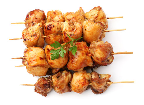 Delicious shish kebabs with parsley isolated on white, top view