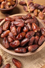 Fototapeta premium Tasty dried dates and bowl on table, closeup