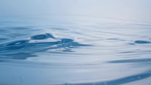 Close-up Abstract Background of Calm Blue Water Ripples and Bubbles on Surface