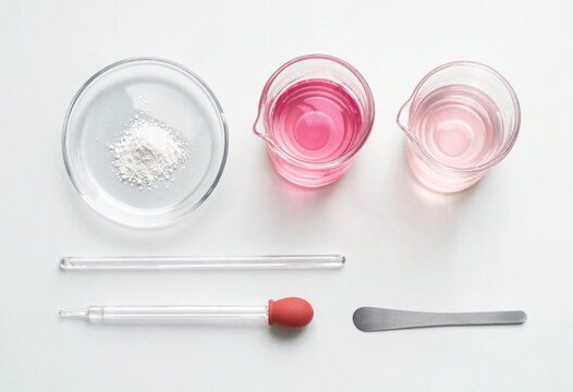 Phenolphthalein Powder and Pink Solutions Flat Lay - Chemistry Laboratory Science Education Concept on White Background