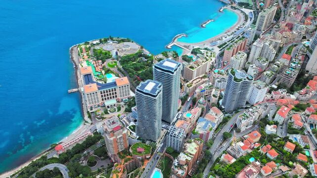 Drone view over Monaco and the French Riviera coastline. High-rise towers, harbour waters and hillside buildings create a luxurious travel panorama.