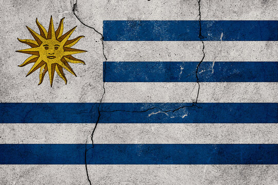 Uruguay Flag with Distressed Texture on a Cracked Concrete Wall for Patriotic and Cultural Themes