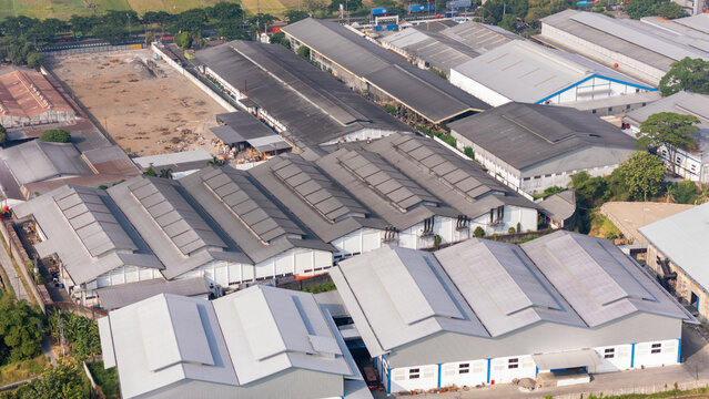 Aerial view of a large industrial complex with multiple interconnected metal-roofed factory buildings and surrounding infrastructure in Central Java, Indonesia.