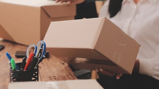 Young asian business woman startup sme small business entrepreneur SME distribution warehouse with parcel mail box. SME Online marketing and product packaging and delivery service.