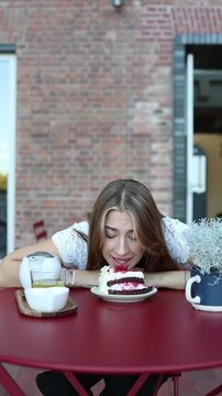 Vertical screen strict dieting leads to a setback as woman gives in to cravings and eats cake showing how food restriction can trigger overeating and loss of self control again