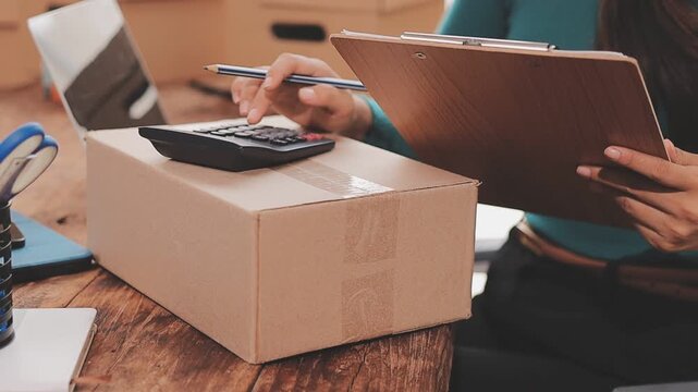 Young asian business woman startup sme small business entrepreneur SME distribution warehouse with parcel mail box. SME Online marketing and product packaging and delivery service.
