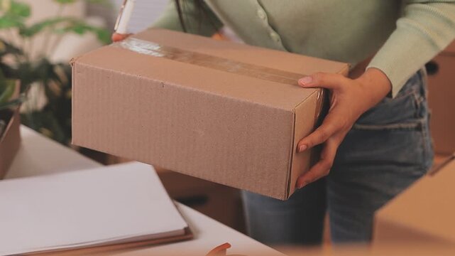 Young asian business woman startup sme small business entrepreneur SME distribution warehouse with parcel mail box. SME Online marketing and product packaging and delivery service.