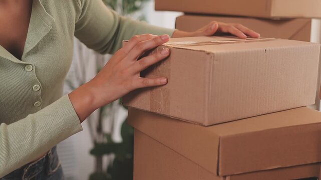 Young asian business woman startup sme small business entrepreneur SME distribution warehouse with parcel mail box. SME Online marketing and product packaging and delivery service.