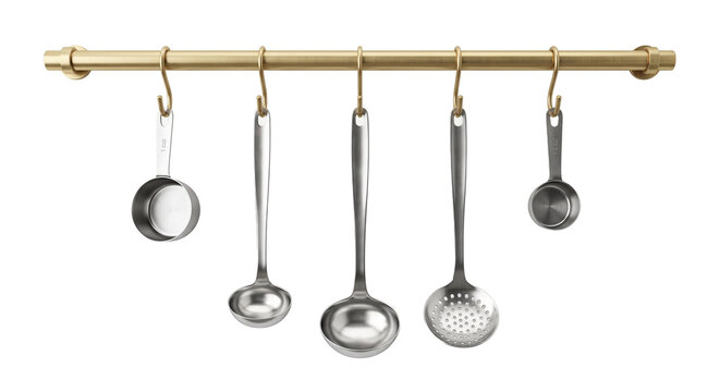 Kitchen utensil set includes ladles and measuring cups hanging from golden rail for organized culinary tools.
