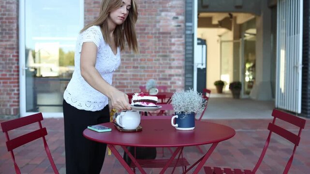 Woman on diet pushes away a slice of cake at outdoor cafe choosing self control over sweet temptation while staying committed to weight loss and healthy eating goals anew
