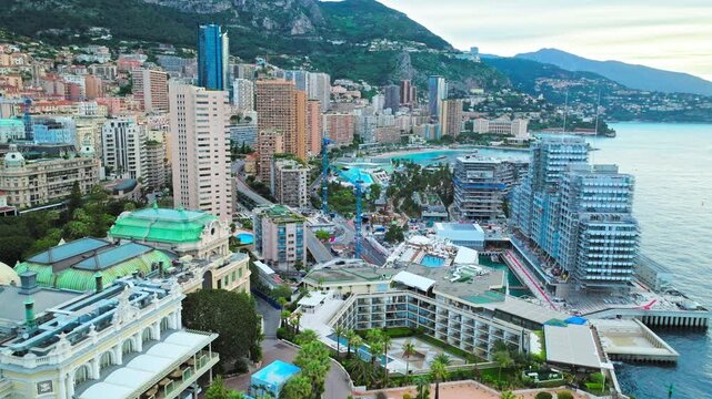 Drone view over Monte Carlo in Monaco. Modern towers, luxury hotels, green rooftops and dense city streets create a refined Riviera cityscape.