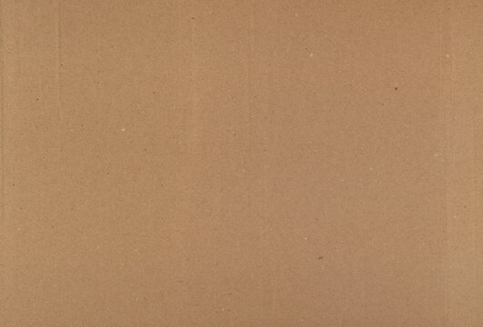 Natural Kraft Cardboard Texture with Visible Fibers Speckles and Faint Fold Marks