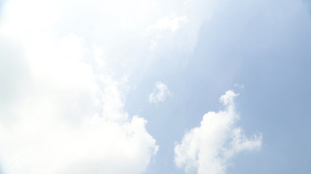 A clear blue sky with soft white clouds