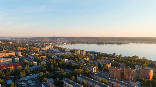 Russia, Votkinsk. Embankment with a dam and factories. Votkinsk is a city in the Udmurt Republic. Sunset time. Drone footage
