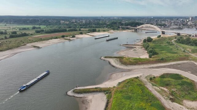Aerial view of heavy shipping traffic on the Waal river during extreme summer drought and low water levels