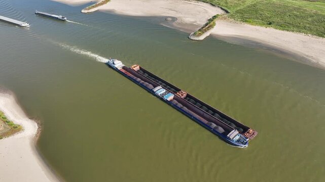 Aerial view of heavy shipping traffic on the Waal river during extreme summer drought and low water levels
