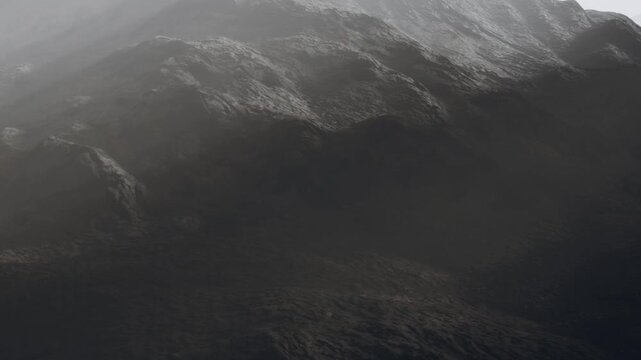 The scene shows mountains covered in mist. The light is soft, indicating early morning. The landscape is uneven with multiple layers of hills fading into the distance.