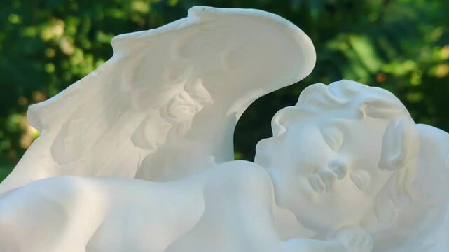 A white statue of an angel with wings, suitable for religious or spiritual themes