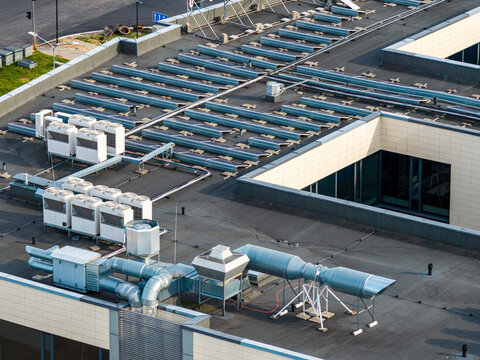 Aerial view of the flat roof of a commercial building featuring multiple HVAC units, ventilation ducts, and skylights in Vilnius, Vilnius County, Lithuania.