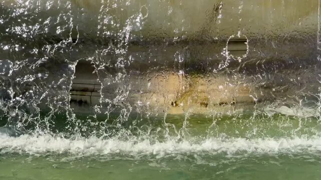 Slow motion static shot of water curtain falling in Vittoriano fountain for video background