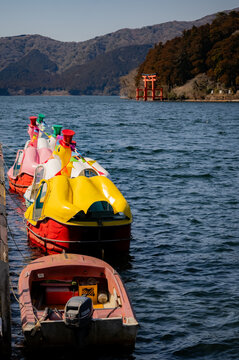 Rental boats and the Hakone Shrine torii gate on Lake Ashi in Hakone, Japan.
