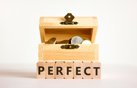 Perfect word symbol. Concept word Perfect on beautiful wooden blocks. Beautiful white table white background. Wooden chest with coins. Business perfect word concept. Copy space.