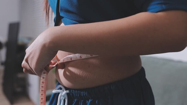 Overweight woman body with hands touching belly fat