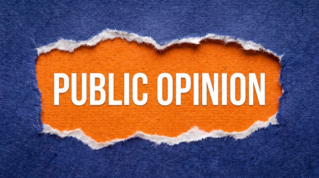 Public opinion text on orange paper torn through dark blue textured board.