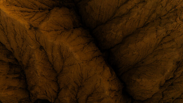 Aerial view of the rugged, textured terrain of the Ak-Say Valley, featuring deep erosion patterns and rocky slopes in At-Bashi District, Naryn Region, Kyrgyzstan.