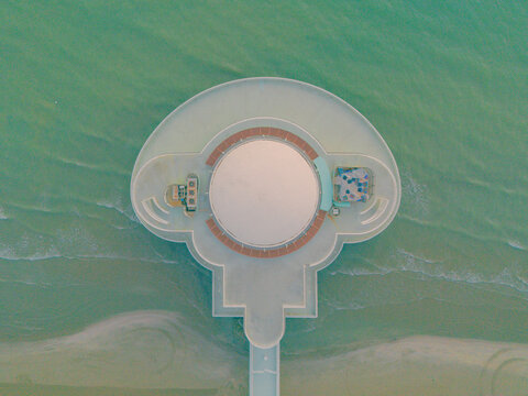 Aerial view of the Rotonda a Mare, a distinctive circular building extending into the Adriatic Sea, featuring a white dome and surrounding walkway, Senigallia, Marche, Italy.