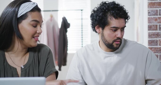 African American duo woman pointing urging man checking watch noting in studio woman typing laptop
