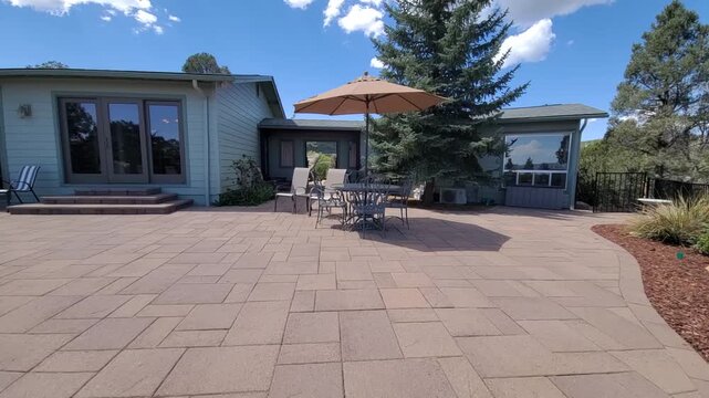 Sunlit patio scene with modern house glass doors umbrella shade, with patio, outdoor, backyard patio