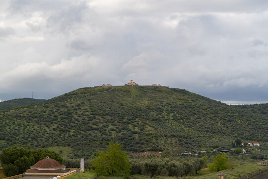 Fortress atop a green hill overlooking olive groves in Elvas Portugal